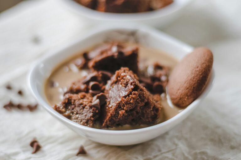 a white bowl filled with brownies and a cookie