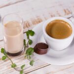 white ceramic teacup set and glass of milk on table