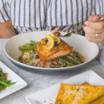 person eating fish meat