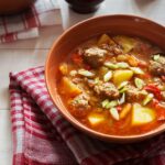 a bowl of soup with meatballs and vegetables